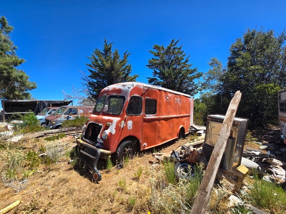 A rusted red van sits among other debris at a newly acquired property that was added to Sierra Azul Open Space Preserve