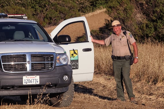 Midpen ranger stands with their truck