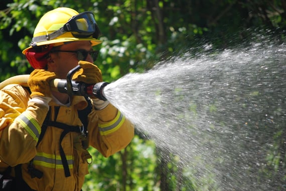 Midpen staff holds a fire hose during annual fire training