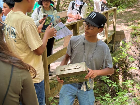 A group of kids discover a geocache in Los Trancos Preserve