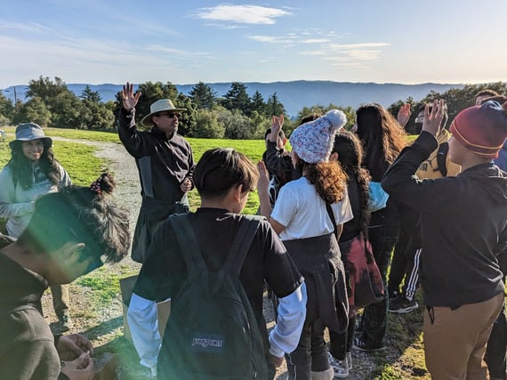 A group of people outside in an open space preserve