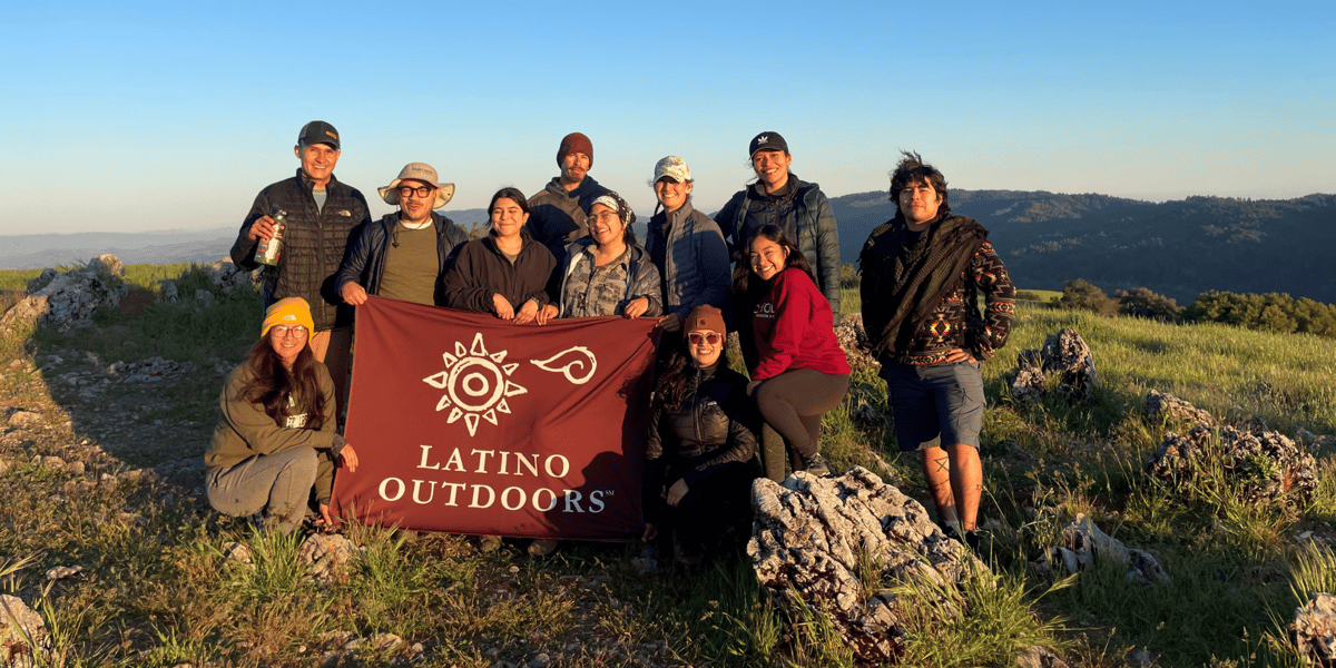 Hikers pose with a banner
