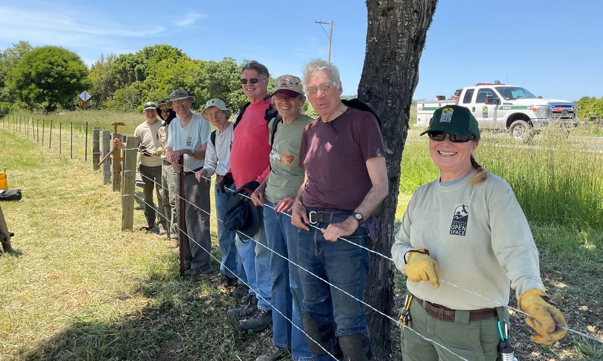 Midpen staff and volunteers with completed fence
