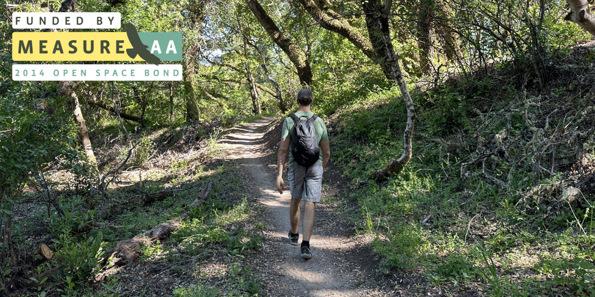 A man walks along newly improved Alpine Road Trail